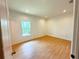 Well-lit bedroom with wooden floors and window providing a cozy and inviting space at 8297 Strasse Blvd, Punta Gorda, FL 33982