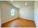 Cozy bedroom with wood floors and window offering a comfortable and private space at 8297 Strasse Blvd, Punta Gorda, FL 33982
