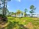 Quaint and charming elevated home with well-manicured lawn surrounded by mature trees at 8297 Strasse Blvd, Punta Gorda, FL 33982