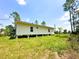 Bright exterior side view featuring a manicured lawn and a newly renovated home at 8297 Strasse Blvd, Punta Gorda, FL 33982