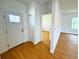 Inviting entryway with hardwood floors, white door, and easy access to other living spaces at 8297 Strasse Blvd, Punta Gorda, FL 33982