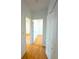 Hallway with wood floors seamlessly connects rooms, offering a cohesive and stylish flow at 8297 Strasse Blvd, Punta Gorda, FL 33982