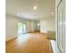 Living room features wood flooring, a door to deck, and seamlessly integrates with kitchen at 8297 Strasse Blvd, Punta Gorda, FL 33982