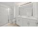 Bright bathroom with double sinks, modern fixtures, and a glass-enclosed shower at 8596 Lunar Skye St, Sarasota, FL 34241