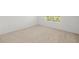 Bright bedroom with a window and neutral carpeting, offering a serene space at 8596 Lunar Skye St, Sarasota, FL 34241
