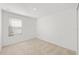 Bright bedroom with a window and neutral carpeting, offering a serene space at 8596 Lunar Skye St, Sarasota, FL 34241