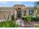 Inviting home exterior with a brick walkway leading to the front door and a well-manicured garden at 9120 Willow Brook Dr, Sarasota, FL 34238