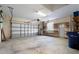 Spacious two-car garage with automatic door, shelving, and a window at 9120 Willow Brook Dr, Sarasota, FL 34238