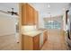 Open kitchen design with bright countertops, wood cabinets, stainless appliances, and tiled floor at 9120 Willow Brook Dr, Sarasota, FL 34238