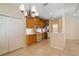 Well-lit kitchen with tiled floor, wooden cabinets, stainless refrigerator, and tile countertops at 9120 Willow Brook Dr, Sarasota, FL 34238