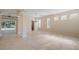 Bright living room with tile flooring, natural light, and views of the pool area at 9120 Willow Brook Dr, Sarasota, FL 34238
