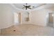 Comfortable living room featuring tile flooring, arched doorways, and built-in shelving at 9120 Willow Brook Dr, Sarasota, FL 34238