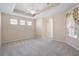 Spacious carpeted main bedroom with a ceiling fan and natural light at 9120 Willow Brook Dr, Sarasota, FL 34238