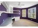 Purple office with built-in desk, storage, and bright windows overlooking the neighborhood at 9120 Willow Brook Dr, Sarasota, FL 34238