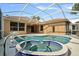 Beautiful pool area with jacuzzi, dolphin statue, and covered patio area perfect for entertaining at 9120 Willow Brook Dr, Sarasota, FL 34238