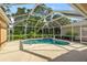 Screened-in pool area with mature trees and landscaping at 9120 Willow Brook Dr, Sarasota, FL 34238