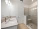 Bathroom featuring a double sink vanity, large mirror, and glass shower in a modern style at 10455 Wet Marsh Cv, Parrish, FL 34219