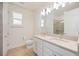 Bright bathroom with double sinks, a large mirror, and a separate toilet room next to the shower at 10455 Wet Marsh Cv, Parrish, FL 34219