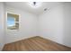 A clean bedroom with hardwood floors, a window and minimalist design at 10455 Wet Marsh Cv, Parrish, FL 34219