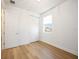 Cozy bedroom featuring light hardwood floors, window with blinds, and closet space at 10455 Wet Marsh Cv, Parrish, FL 34219