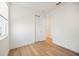 Bright bedroom with light hardwood floors, closet, and natural light from the window at 10455 Wet Marsh Cv, Parrish, FL 34219