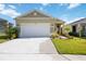 Charming home features a well-manicured lawn, a two-car garage, and an inviting walkway at 10455 Wet Marsh Cv, Parrish, FL 34219