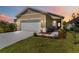 Charming home features a well-manicured lawn, a two-car garage and a welcoming entryway at 10455 Wet Marsh Cv, Parrish, FL 34219