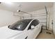 Garage featuring white car, door, and epoxy flooring at 10455 Wet Marsh Cv, Parrish, FL 34219