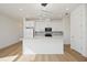 Bright kitchen with an island, modern appliances, and a geometric backsplash under contemporary lighting fixtures at 10455 Wet Marsh Cv, Parrish, FL 34219