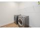 Laundry room featuring new washer and dryer with shelf at 10455 Wet Marsh Cv, Parrish, FL 34219
