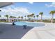 Large community pool area with many palm trees at 10455 Wet Marsh Cv, Parrish, FL 34219