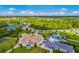 Aerial view of the community playground, splash pad, tennis courts, and clubhouse amenities at 12676 Sagewood Dr, Venice, FL 34293