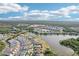 Expansive aerial shot showcasing the community's layout around a tranquil lake, highlighting neighborhood's serene atmosphere and nature at 12676 Sagewood Dr, Venice, FL 34293