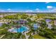 Aerial view of the community pool and recreation area surrounded by trees and lush lawns at 12676 Sagewood Dr, Venice, FL 34293