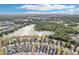 Stunning aerial view of a residential community with a lake and lush green spaces at 12676 Sagewood Dr, Venice, FL 34293