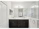 Elegant bathroom featuring a double sink vanity, a large mirror, and a shower with marble tile at 12676 Sagewood Dr, Venice, FL 34293