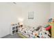 Bedroom featuring neutral walls, a gray rug, artwork, and plenty of natural light at 12676 Sagewood Dr, Venice, FL 34293