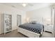 Bright bedroom with a plush bed, side tables, and a bookshelf; creating a cozy retreat at 12676 Sagewood Dr, Venice, FL 34293