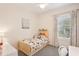 Cozy bedroom with a large window, artwork, a ceiling fan, and a playful bed set at 12676 Sagewood Dr, Venice, FL 34293