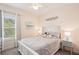 Comfortable bedroom featuring a queen-sized bed with white wood frame and neutral decor at 12676 Sagewood Dr, Venice, FL 34293