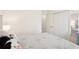Bright bedroom with white walls, closet, and neutral bedding offers a peaceful retreat at 12676 Sagewood Dr, Venice, FL 34293