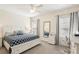 Cozy bedroom featuring a queen-sized bed with stylish patterned bedding and comfortable desk area at 12676 Sagewood Dr, Venice, FL 34293