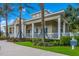 Attractive clubhouse with columns, a porch, and manicured landscaping for community residents at 12676 Sagewood Dr, Venice, FL 34293