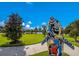 Scenic community featuring a colorful dolphin statue, manicured lawns, and a serene lake view at 12676 Sagewood Dr, Venice, FL 34293