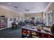 Community center features tables, chairs, bookshelves, games, and a television for resident enjoyment at 12676 Sagewood Dr, Venice, FL 34293