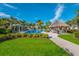 Resort-style community pool with palm trees, cabanas, and ample seating at 12676 Sagewood Dr, Venice, FL 34293
