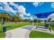 Well-equipped dog park with shaded seating, play structures, and a waste station for community residents at 12676 Sagewood Dr, Venice, FL 34293