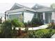 Inviting exterior view with lush landscaping, a winding walkway, and an attached two-car garage at 12676 Sagewood Dr, Venice, FL 34293