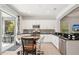 Eat-in kitchen boasting modern stainless steel appliances and views of the lanai at 12676 Sagewood Dr, Venice, FL 34293