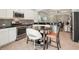 Bright kitchen area featuring stainless appliances, dark countertops, and an eat-in table at 12676 Sagewood Dr, Venice, FL 34293